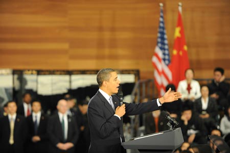 US President Barack Obama gestures as he delivers a speech at a dialogue with Chinese youth at the Shanghai Science and Technology Museum during his four-day state visit to China, November 16, 2009.
