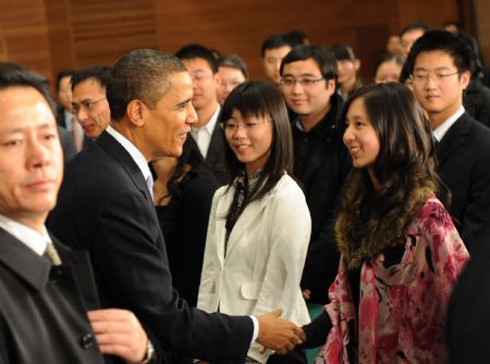 US President Barack Obama shakes hands with Chinese students after having a dialogue with Chinese youths at the Shanghai Science and Technology Museum during his four-day state visit to China, November 16, 2009.