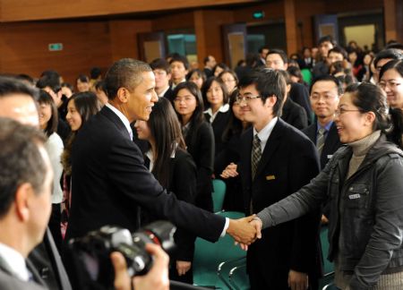 US President Barack Obama shakes hands with Chinese students after having a dialogue with Chinese youths at the Shanghai Science and Technology Museum during his four-day state visit to China, November 16, 2009.