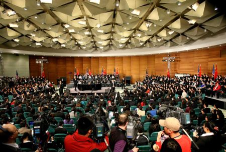 US President Barack Obama gestures as he delivers a speech at a dialogue with Chinese youths at the Shanghai Science and Technology Museum during his four-day state visit to China, November 16, 2009. 