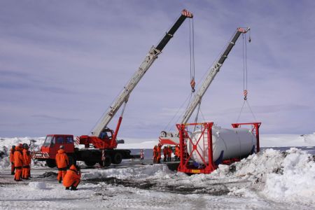 Chinese exploration team unloads an oil tank at the port of the Great Wall Station in Antarctic, November 16, 2009.