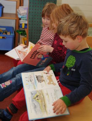 Children read books at a kindergarten in Finland, on November 16, 2009. Finnish children enjoy their childhood a lot thanks to the pleasant climate and environment as well as the free pre-school education provided by the local government.