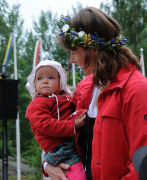 A woman holds her child in her arms in Finland, on June 19, 2009.