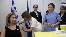 Greek Health Minister Mariliza Xenoyiannakopoulou (L) receives A/H1N1 flu vaccination in Athens, capital of Greece, November 16, 2009.The vaccination program against A/H1N1 flu began in Greece on Monday.
