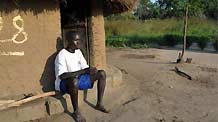 Denis Opoka sits in front of his hut at Ajulu village, in Gulu district, northern Uganda, on October 20, 2009.