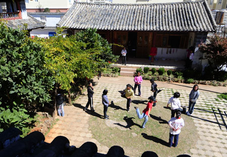 A bevy of girl students scamper about in rope skipping on the campus of the Orphanage School for Ethnic Minorities in Lijiang, southwest China's Yunnan Province, October 24, 2009. 