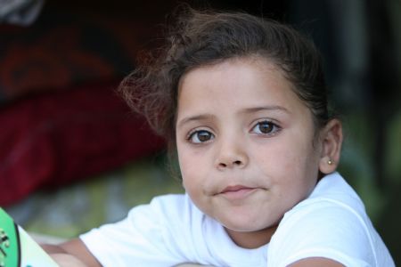 Mona Khader poses for a photo near the tent, in which she lives in the Gaza Strip, on October 29, 2009.