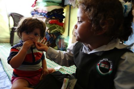 Mona Khader looks after her youngest sister Kholoud in the tent, in which she lives in the Gaza Strip, on October 29, 2009. 