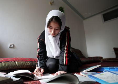 Aysha does her homework in Kabul, capital of Afghanistan, on November 1, 2009.