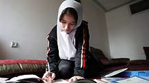 Aysha does her homework in Kabul, capital of Afghanistan, on November 1, 2009.