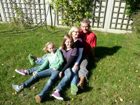 Flora (2nd L) and Valentina (1st L) pose for a group photo with their parents at their home in Purkersdorf, a town of Lower Austria, Austria, on October 4, 2009.