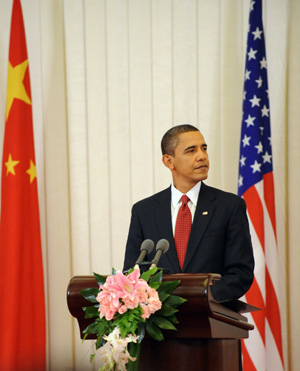 Visiting US President Barack Obama reacts during a press conference held with Chinese President Hu Jintao following their official talks at the Great Hall of the People in Beijing on November 17, 2009. 