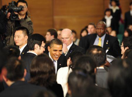 US President Barack Obama talks with Chinese students after delivering a speech at a dialogue with Chinese youths at the Shanghai Science and Technology Museum during his four-day state visit to China, November 16, 2009.