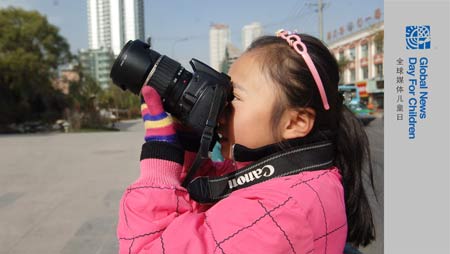 Zhang Jiaqi practises taking photos in downtown Xining on October 31, 2009. Zhang Jiaqi, ten-year-old, a firth-grade pupil of the Jiaxiaozhuang Primary School in Xining, northwest China's Qinghai Province. 