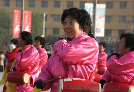 A group of retired women play waist drum, a popular musical instrument in norther region of China, together for joy at a street corner in downtown Xining, on October 31, 2009.