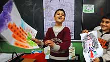 Sanlong (L) and his brother imitate the teacher teaching in painting class in Wu'ai Primary School in Yiwu City, east China's Zhejiang Province, November 13, 2009.