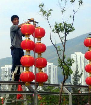 A worker hangs red lanterns in downtown Hong Kong, south China, in this photo taken by Liang Zhuoru in 2009. 