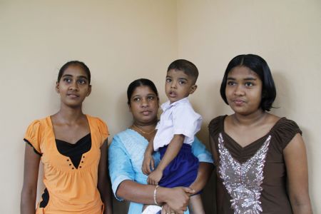 Photo taken on November 6, 2009 shows Heshani(R), her sister(L) and their neighbor, whose daughter is their friend but killed by the tsunami in 2004. 