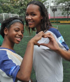 Photo taken on October 5, 2009 shows Maria Luisa (L) plays with her friend at school in Rio De Janeiro of Brazil. 