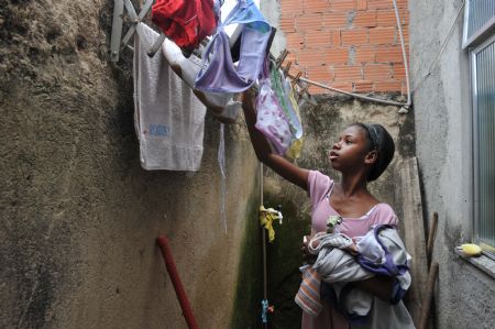 Photo taken on October 5, 2009 shows Maria Luisa does housework at home in Rio De Janeiro of Brazil.