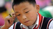 Xu Zhongzheng studies by himself during break in the New Primary School of Dujiangyan City of Chengdu, capital of southwest China's Sichuan Province, November 11, 2009.