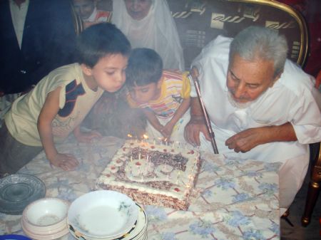 This picture taken on August 1, 2008 shows on my grandma and grandpa's 50th wedding anniversary, grandpa blows off the candles and it makes a lot of smoke.