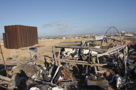 Palestinians inspect damages of underground tunnels on Gaza's southern border with Egypt following Israeli airstrikes November 19, 2009.