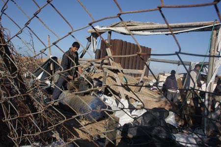 Palestinians inspect damages of underground tunnels on Gaza's southern border with Egypt following Israeli airstrikes November 19, 2009.