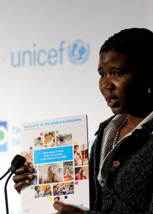 Grace Akallo, former child soldier from Uganda, shows 'The State of the World's Children' report to the media during a news conference at the UN Children's Fund (UNICEF) headquarters in New York November 19, 2009.