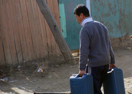 The photo I took on October 27 shows a local resident carries water in Ulan Bator. 