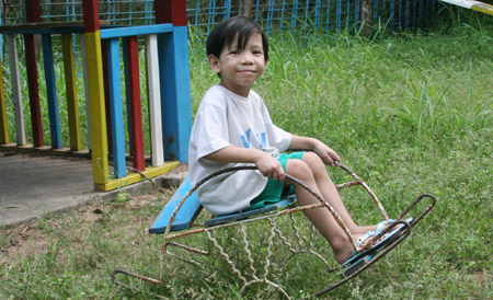 A child amuses himself at the Htauk Kyant Orphanage in Yangon, Myanmar, on November 18, 2009. 