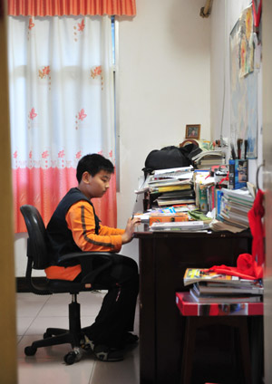 Liu Danyang does his homework at home on November 1, 2009 in Yichang, city of central China's Hubei Province. 