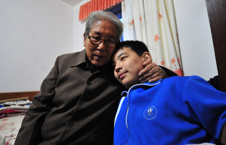 Liu Danyang leans close to his grandma at home on November 3, 2009 in Yichang, city of central China's Hubei Province.