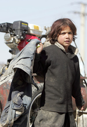 Asma takes care of their roadside workshop after her brothers go to school in Kabul, capital of Afghanistan, on October 31, 2009. 