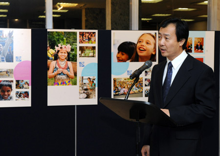 Zeng Hu, deputy president of the North America Bureau of Xinhua News Agency, reads the written speech composed by Li Congjun, president of Xinhua News Agency, during the opening ceremony of a photo exhibition marking the Universal Children's Day at the headquarters of the United Nations (UN) in New York, the U.S., Nov. 19, 2009. 