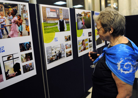 A visitor looks at the photos during a photo exhibition marking the Universal Children's Day at the headquarters of the United Nations (UN) in New York, the U.S., Nov. 19, 2009. 