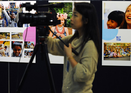 A camerawoman shoots a photo exhibition marking the Universal Children's Day at the headquarters of the United Nations (UN) in New York, the US, November 19, 2009.