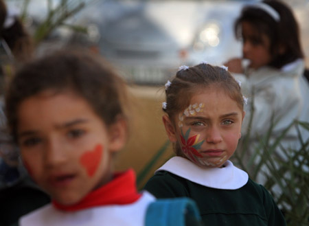 Palestinian children have their faces painted and gather to commemorate the Universal Children's Day, which falls on Friday, near their home, south of Gaza City, November 19, 2009. 