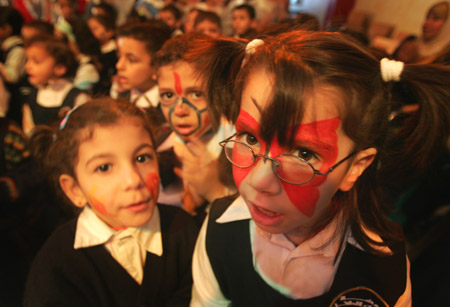 Palestinian children have their faces painted and gather to commemorate the Universal Children's Day, which falls on Friday, near their home, south of Gaza City, November 19, 2009. 