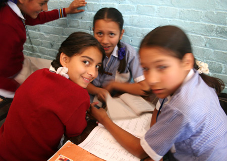 Jyoti Upreti (L) plays games with her classmates at school in Kathmandu, capital of Nepal, on October 28, 2009. 