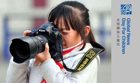 The undated photo shows Guo Xinxuan taking pictures, in Taiyuan city, capital of north China's Shanxi Province. I am Guo Xinxuan, nine years old, studying at Qingnianlu Primary School in Taiyuan City. I like reading and playing games with my friends. I like my father and mother most, and my dog Rousong as well. I also like camera, because it can record everything I like.