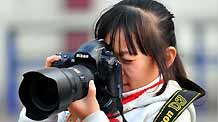 The undated photo shows Guo Xinxuan taking pictures, in Taiyuan city, capital of north China's Shanxi Province. I am Guo Xinxuan, nine years old, studying at Qingnianlu Primary School in Taiyuan City. I like reading and playing games with my friends. I like my father and mother most, and my dog Rousong as well. I also like camera, because it can record everything I like.