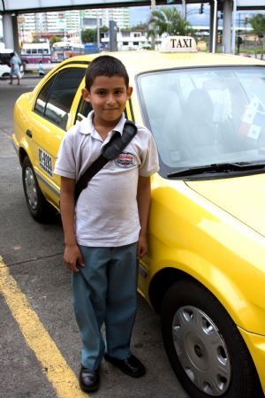 Eduardo Loayza poses beside his father's cab in Panama, October 23, 2009. 