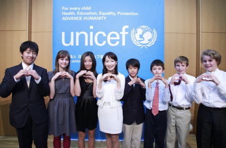 The UN Children's Fund (UNICEF) Goodwill Ambassador and singer Agnes Chan from Hong Kong (4th L) gestures with children live in Japan at an activity to mark the Universal Children's Day and the 20th anniversary of the adoption of the UN Convention on the Rights of the Child (CRC) in Tokyo, capital of Japan, November 20, 2009, the day of Universal Children's Day. 