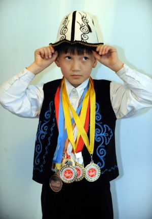 Elnur shows the medals he ever won at home in Bishkek, capital of Kyrgyzstan, on October 28, 2009. 