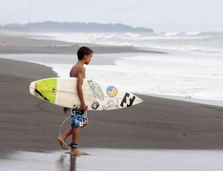 Leonardo Calvo Arrieta prepares to go surfing in Puntarenas, Costa Rica, on November 5, 2009.