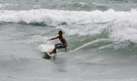 Leonardo Calvo Arrieta goes surfing in Puntarenas, Costa Rica, on November 5, 2009. 