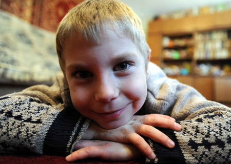 Eight-year-old Sacha poses for a photograph at Voenno-antonovskiy Orphan School in Bishkek, capital of Kyrgyzstan, November 19, 2009. 