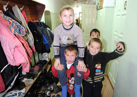 Ten-year-old Danil (L, Bottom) and his younger brother Sacha (L, Top) play with their friends at the dorm of Voenno-antonovskiy Orphan School in Bishkek, capital of Kyrgyzstan, November 19, 2009.