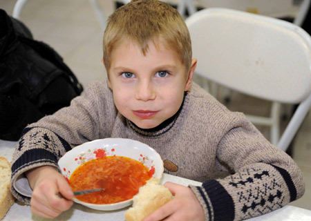 Eight-year-old Sacha has his lunch at the dining hall of Voenno-antonovskiy Orphan School in Bishkek, capital of Kyrgyzstan, November 19, 2009.